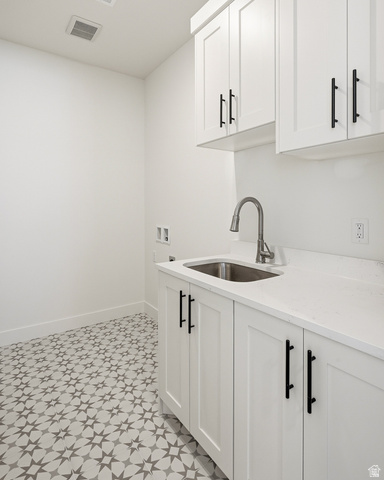 4978 North 75 East Enoch, UT 84721 - Photo 31 of 60 Laundry area featuring hookup for a washing machine, light floors, and cabinet space