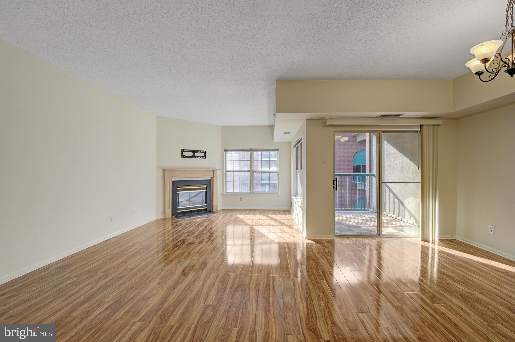 6146 Main Street Voorhees, NJ 08043 - Photo 12 of 40 a view of empty room with wooden floor and fan