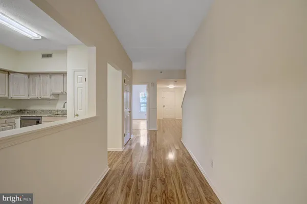 a view of a kitchen with wooden floor