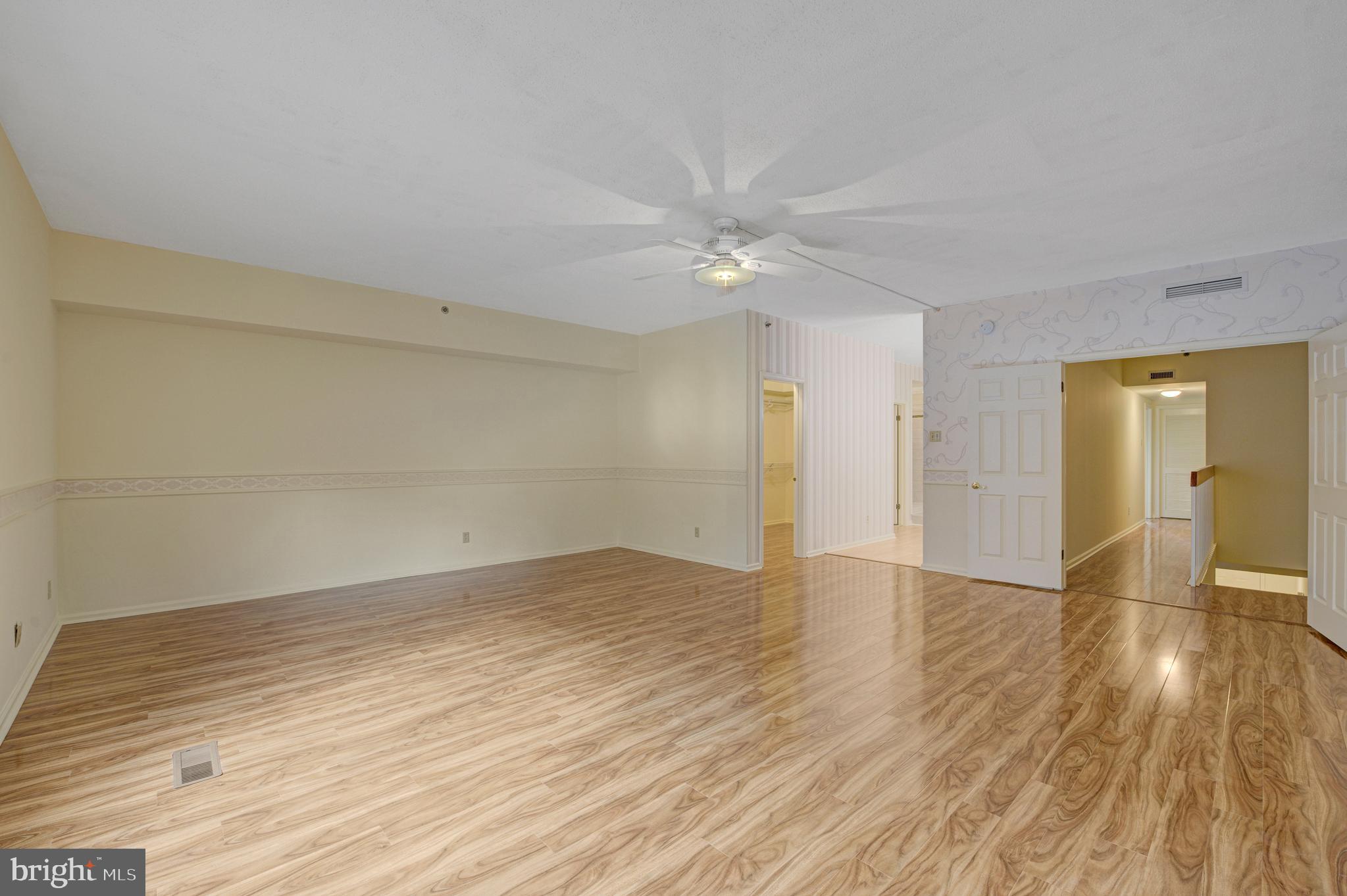 6146 Main Street Voorhees, NJ 08043 - Photo 18 of 40 an empty room with wooden floor and ceiling fan