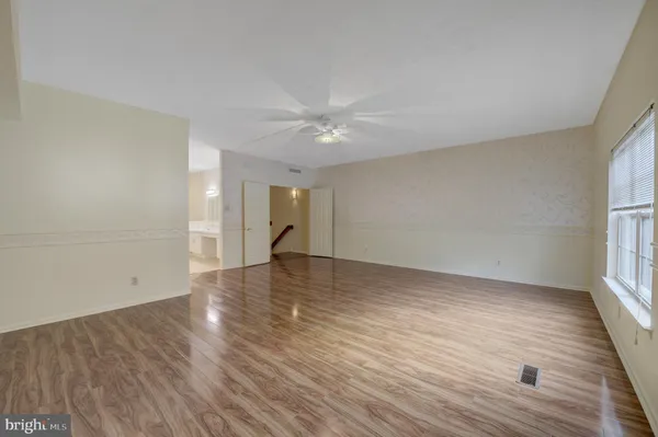 wooden floor in an empty room with a window