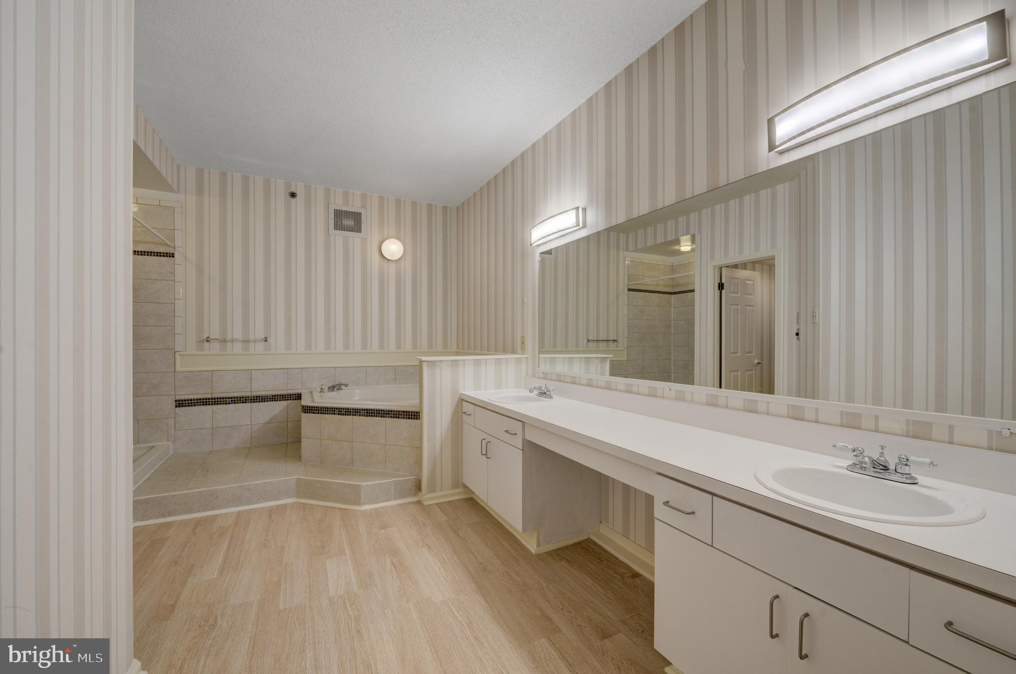 6146 Main Street Voorhees, NJ 08043 - Photo 21 of 40 a bathroom with a tub sink and mirror