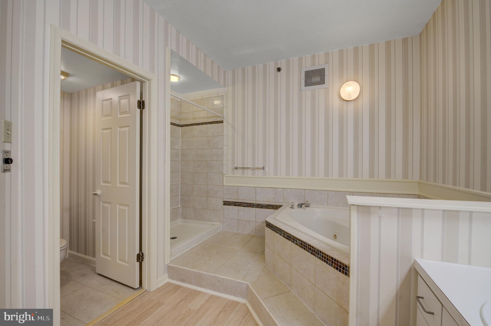 6146 Main Street Voorhees, NJ 08043 - Photo 22 of 40 a bathroom with a bathtub and a shower
