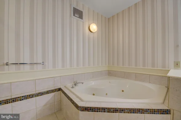 a bathroom with a bathtub and shower