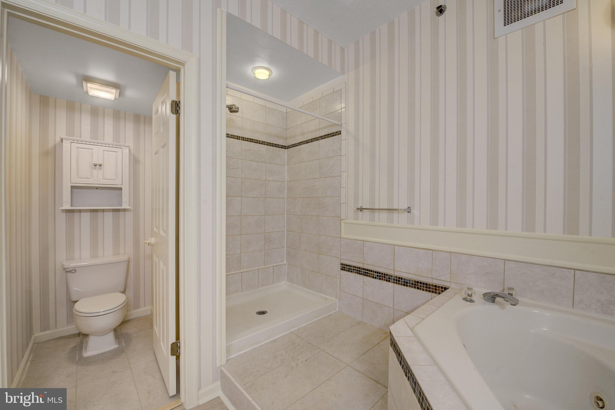 6146 Main Street Voorhees, NJ 08043 - Photo 25 of 40 a bathroom with a bathtub and a shower