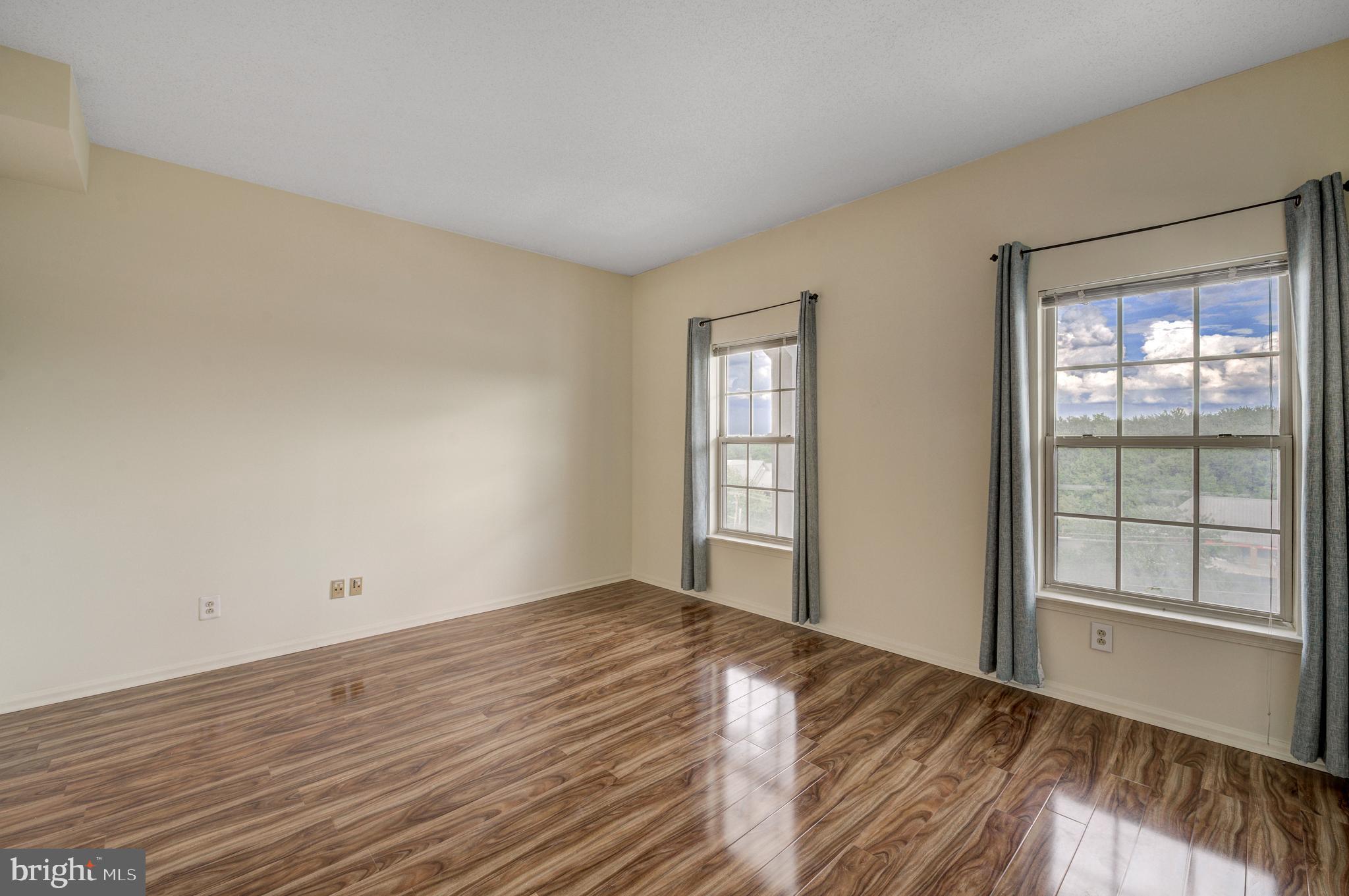 6146 Main Street Voorhees, NJ 08043 - Photo 28 of 40 a view of empty room with wooden floor and fan