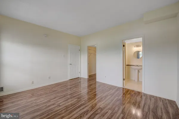 a view of an empty room and wooden floor