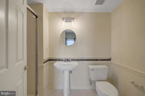 a white toilet sitting next to a shower