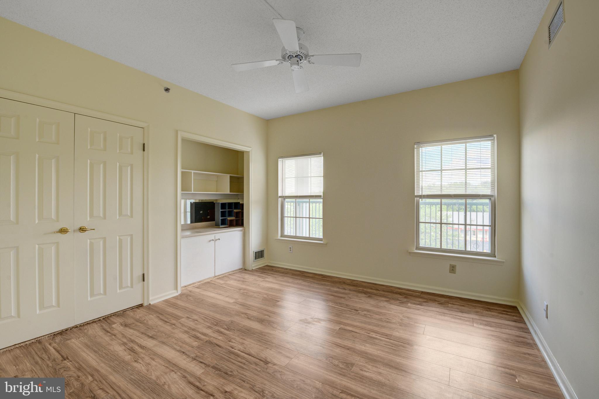 6146 Main Street Voorhees, NJ 08043 - Photo 5 of 40 a view of an empty room with window and wooden floor