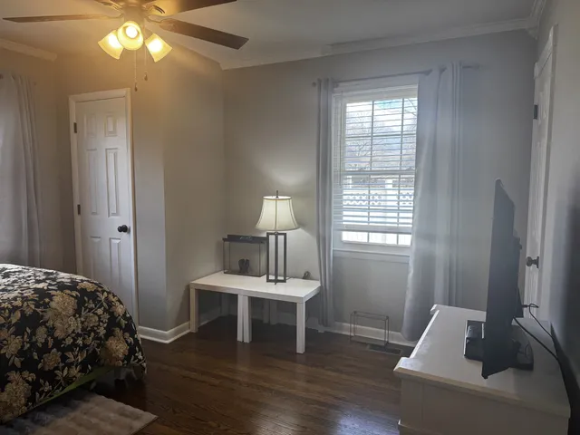 a bedroom with a bed and a window