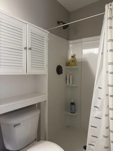 a bathroom with a shower toilet and sink
