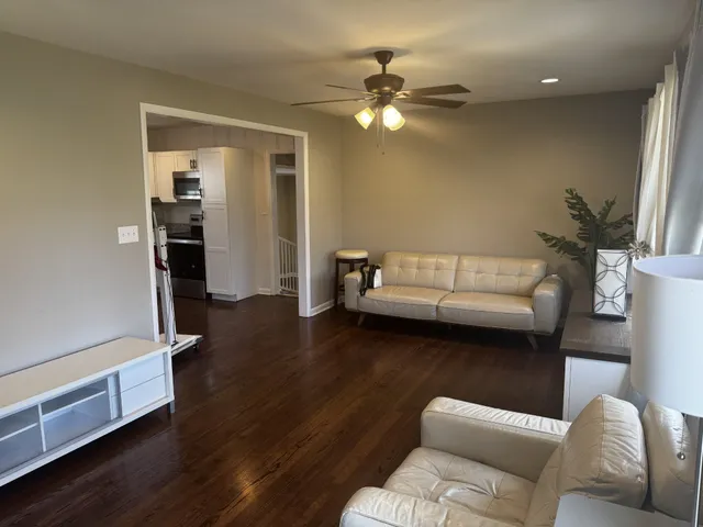 a living room with furniture and a chandelier