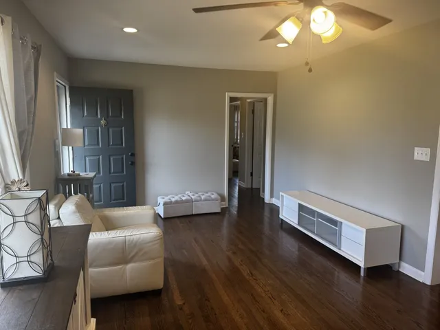 a living room with furniture and a chandelier