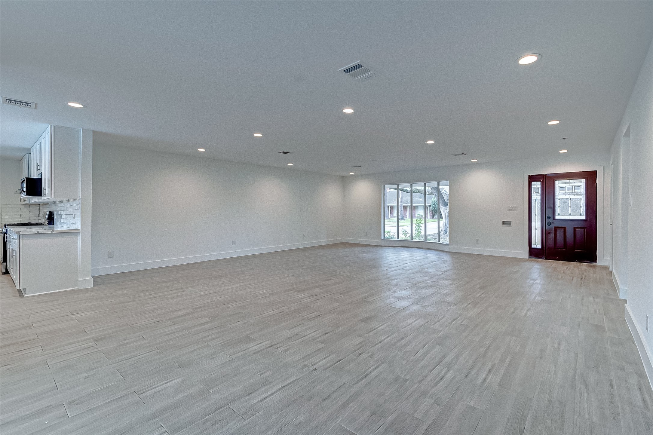 5007 Cheena Drive Houston, TX 77096 - Photo 11 of 40 a view of an empty room with a window and wooden floor