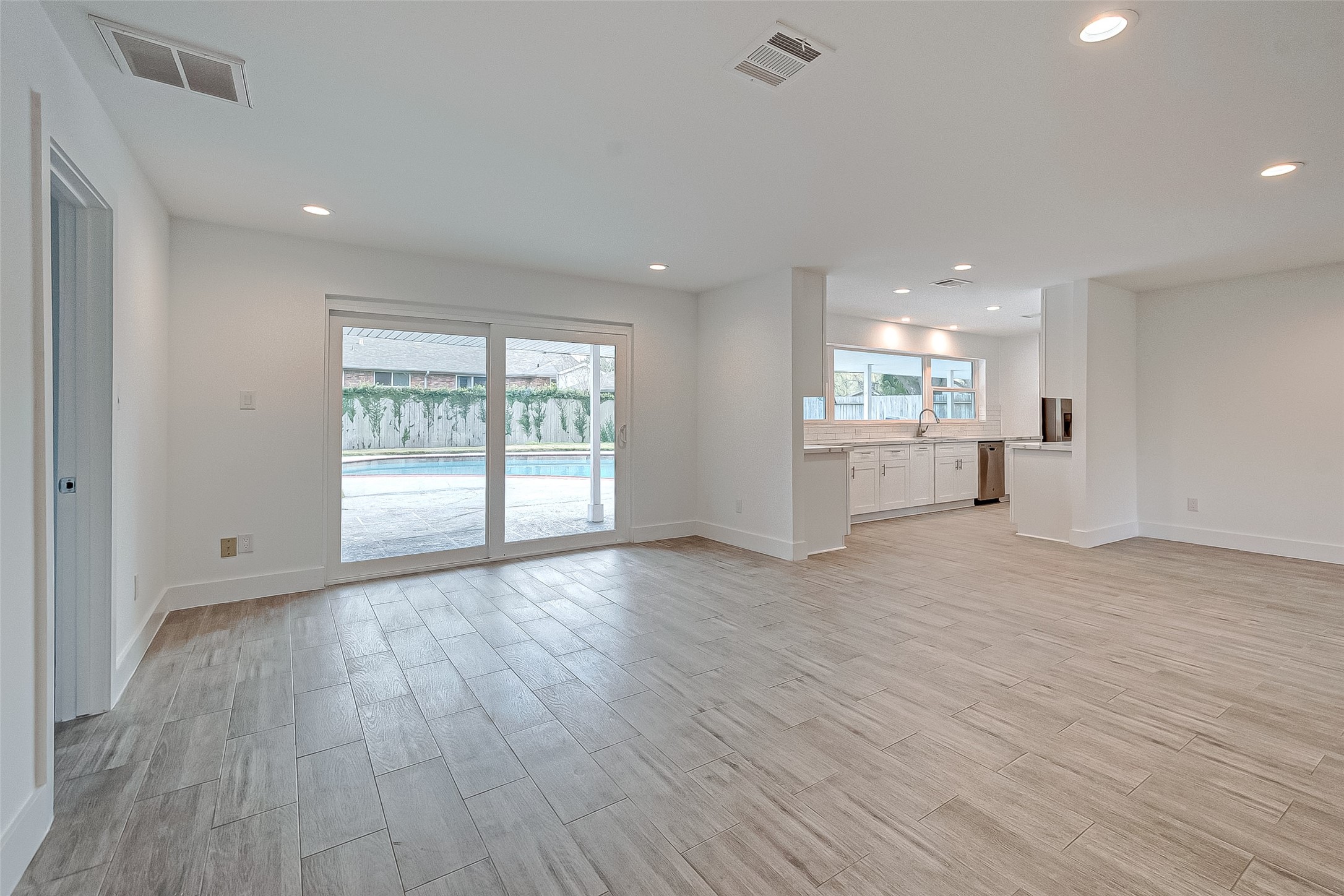 5007 Cheena Drive Houston, TX 77096 - Photo 12 of 40 a view of an empty room with a window and wooden floor