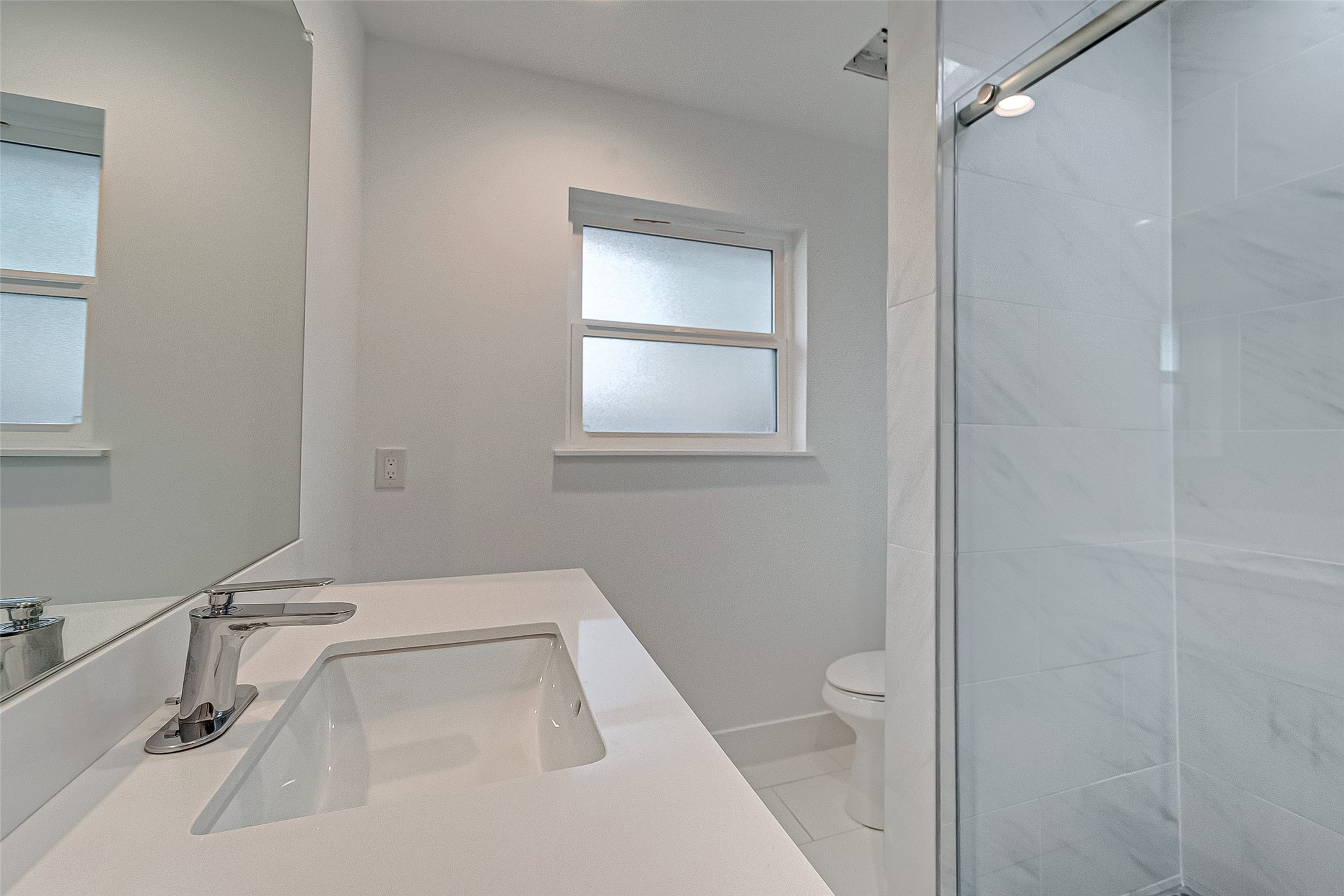 5007 Cheena Drive Houston, TX 77096 - Photo 24 of 40 a bathroom with a sink a toilet and a mirror