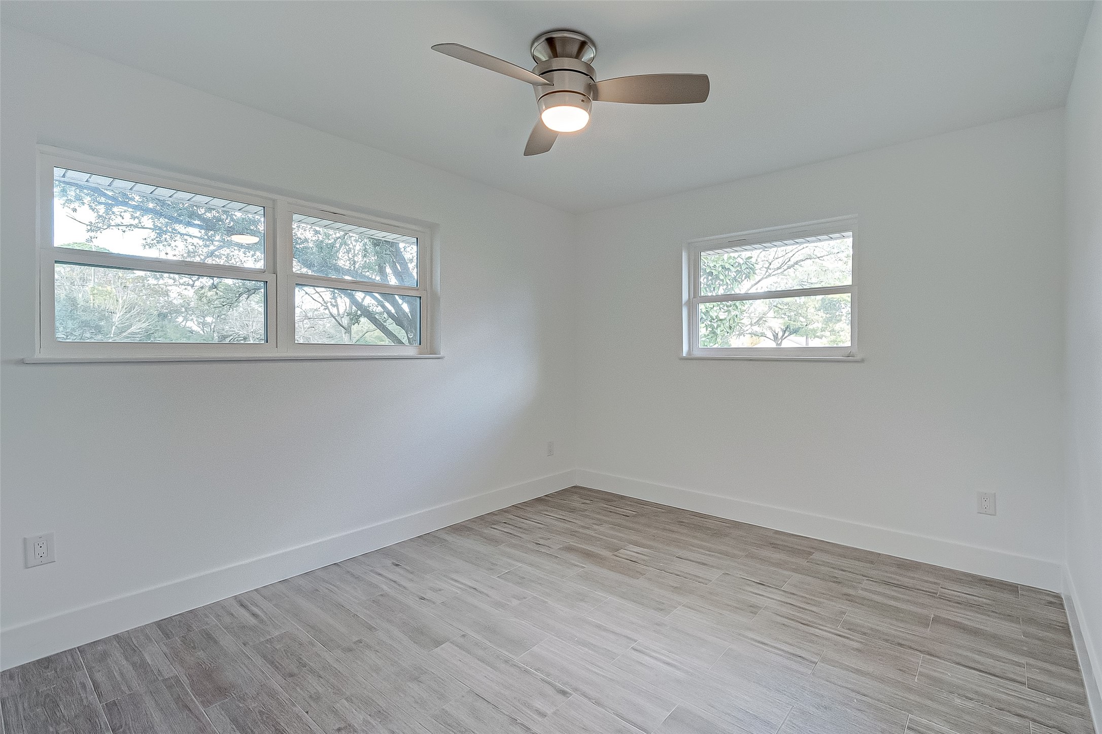 5007 Cheena Drive Houston, TX 77096 - Photo 26 of 40 a view of empty room with wooden floor and fan