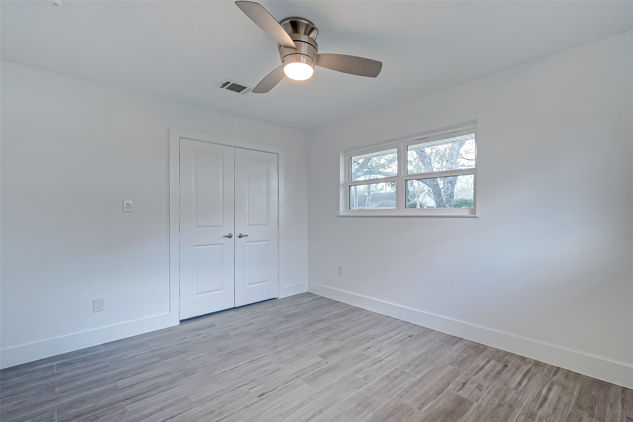 5007 Cheena Drive Houston, TX 77096 - Photo 27 of 40 a view of an empty room with wooden floor and a window