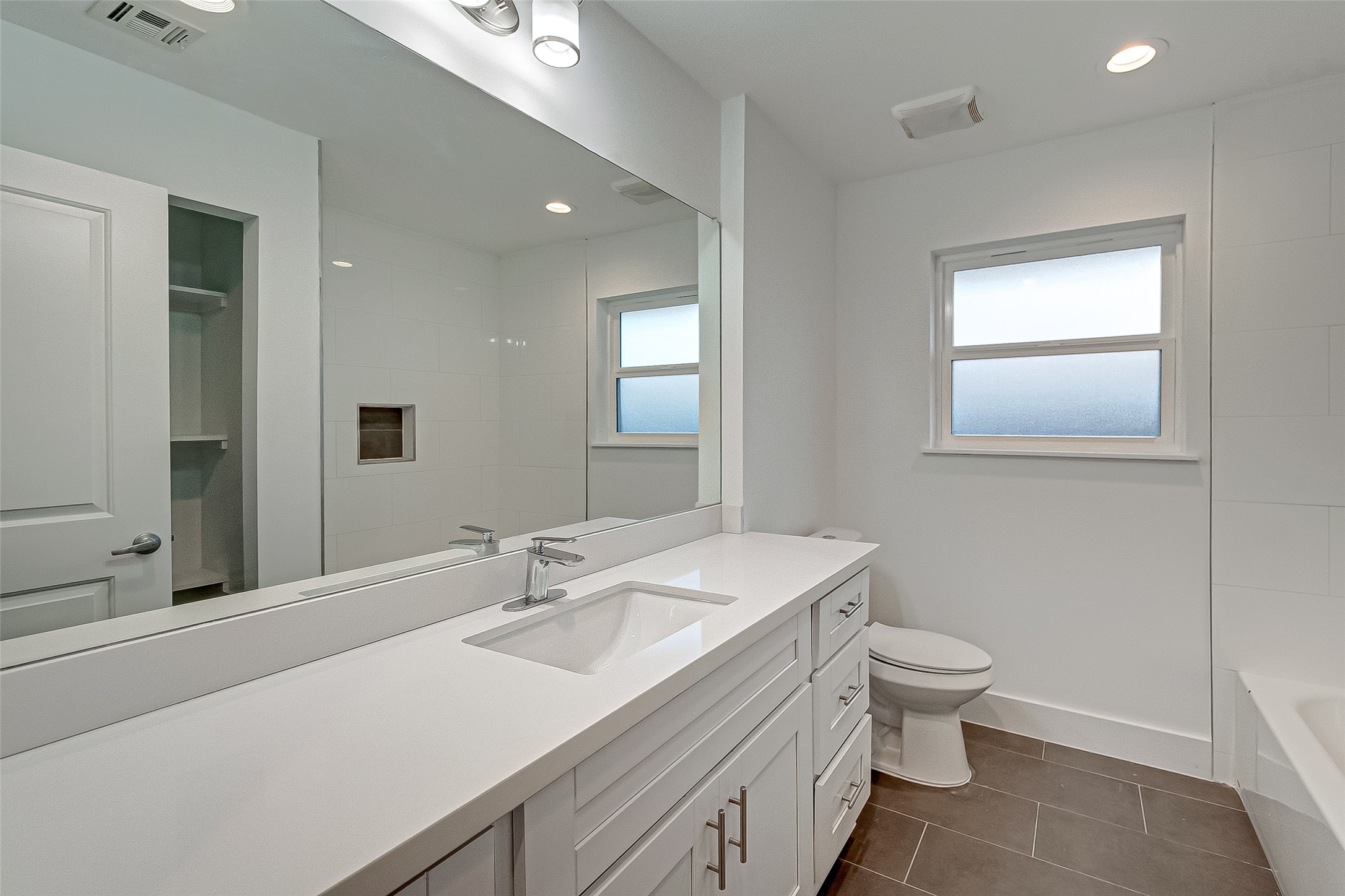 5007 Cheena Drive Houston, TX 77096 - Photo 28 of 40 a bathroom with a sink toilet and mirror