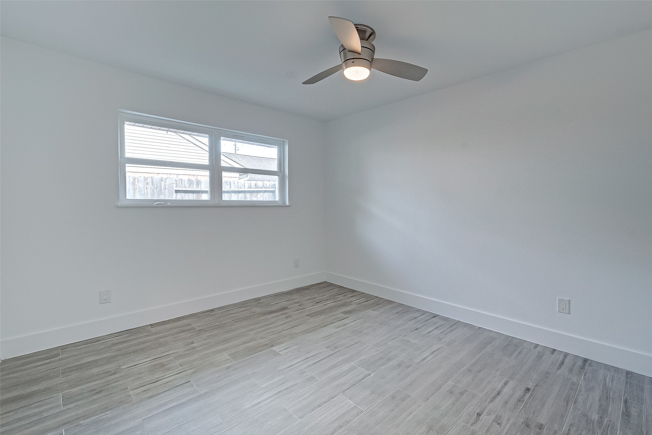 5007 Cheena Drive Houston, TX 77096 - Photo 30 of 40 wooden floor in an empty room with a window