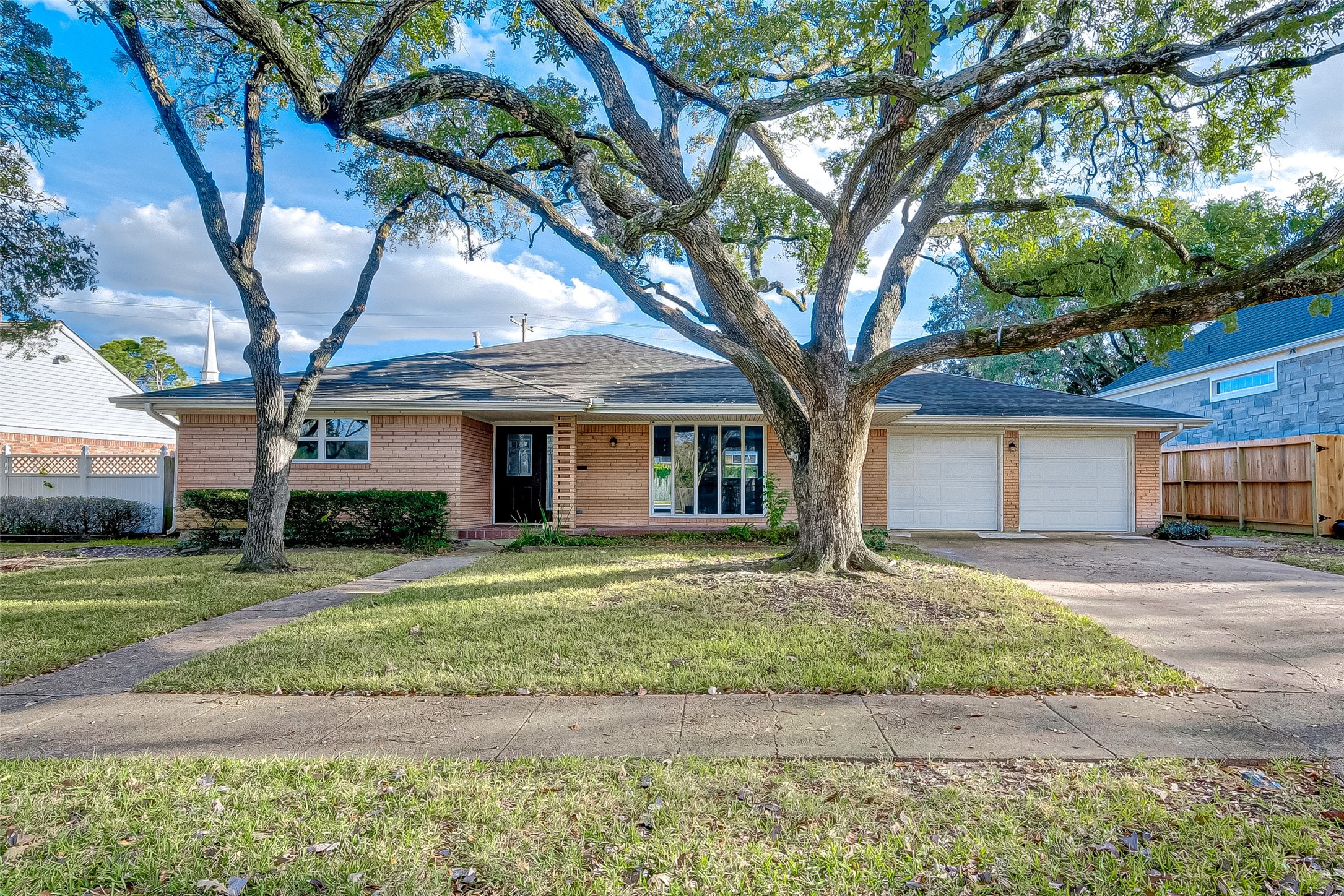 5007 Cheena Drive Houston, TX 77096 - Photo 3 of 40 a front view of a house with a yard and garage