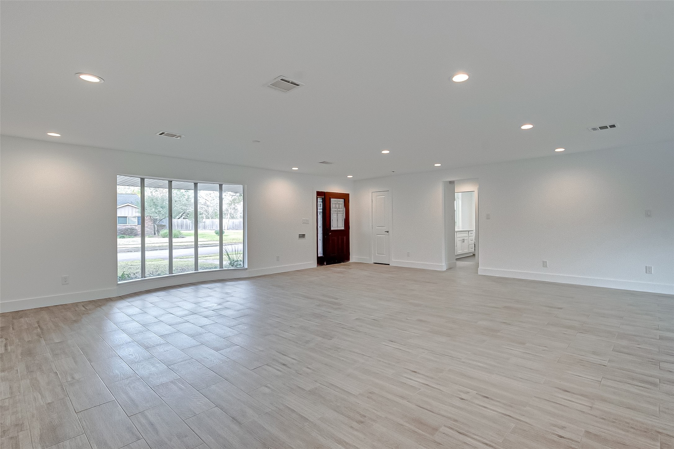 5007 Cheena Drive Houston, TX 77096 - Photo 9 of 40 a view of an empty room with wooden floor and a window