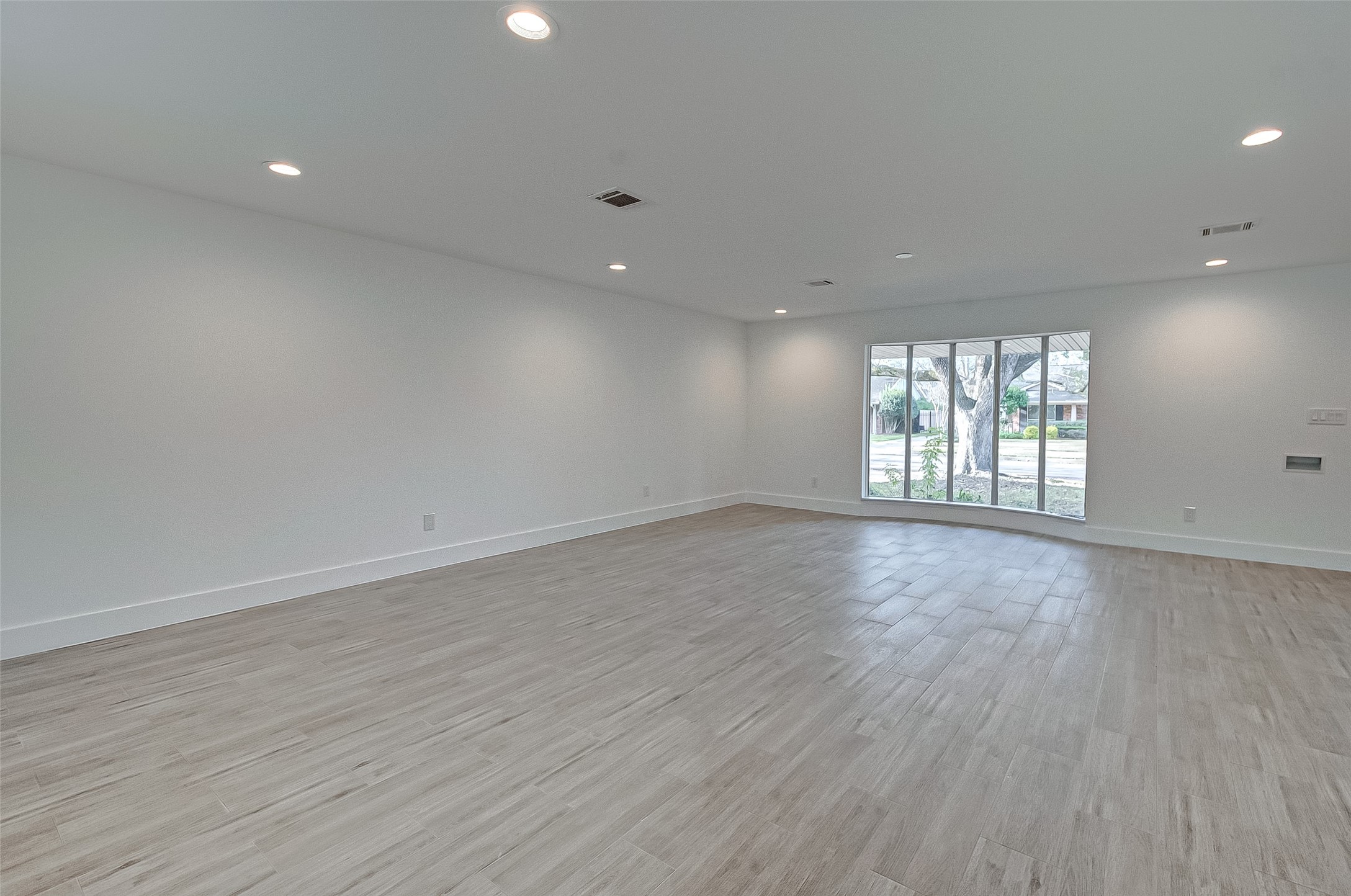 5007 Cheena Drive Houston, TX 77096 - Photo 10 of 40 an empty room with wooden floor and windows