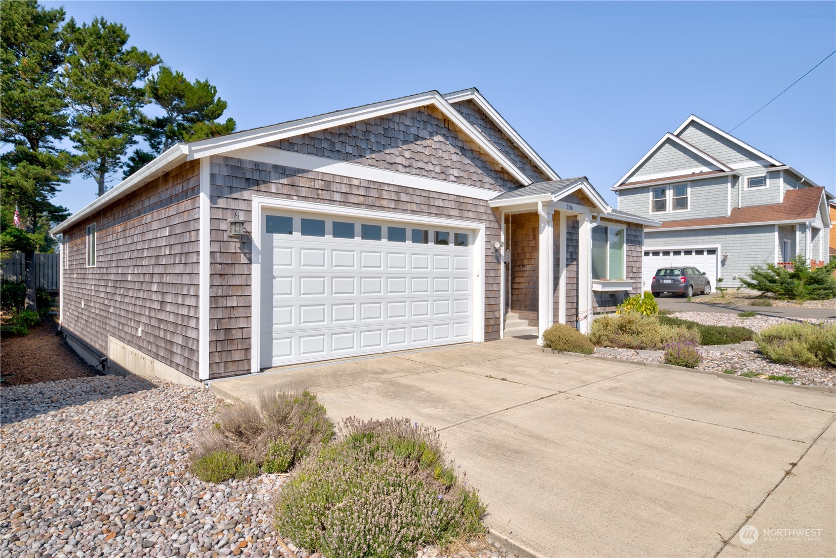206 Pioneer Road West Long Beach, WA 98631 - Photo 32 of 39 a front view of a house with a garage