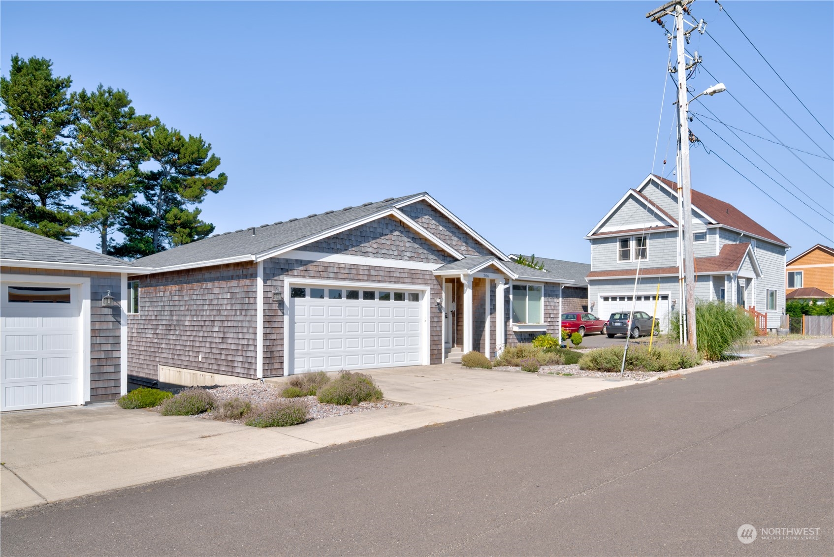 206 Pioneer Road West Long Beach, WA 98631 - Photo 33 of 39 a front view of a house with a yard and garage