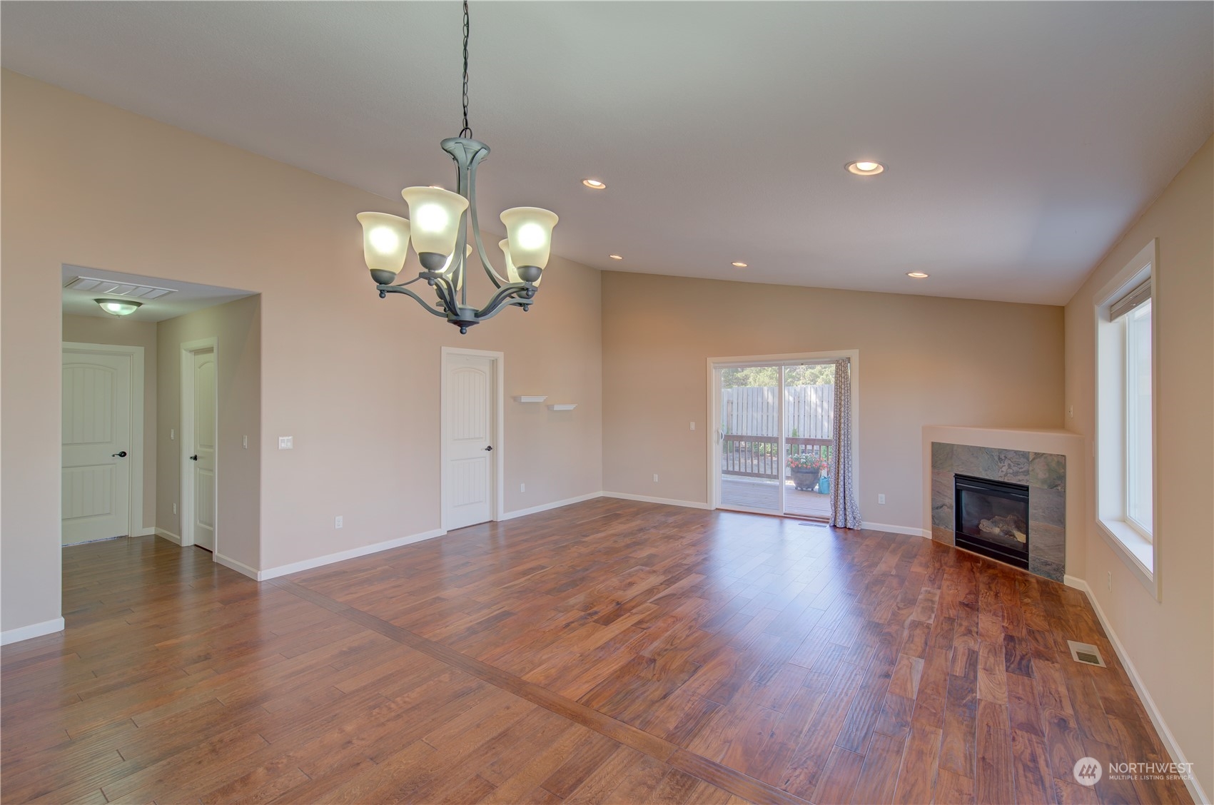 206 Pioneer Road West Long Beach, WA 98631 - Photo 9 of 39 a view of an empty room with wooden floor fireplace and a window