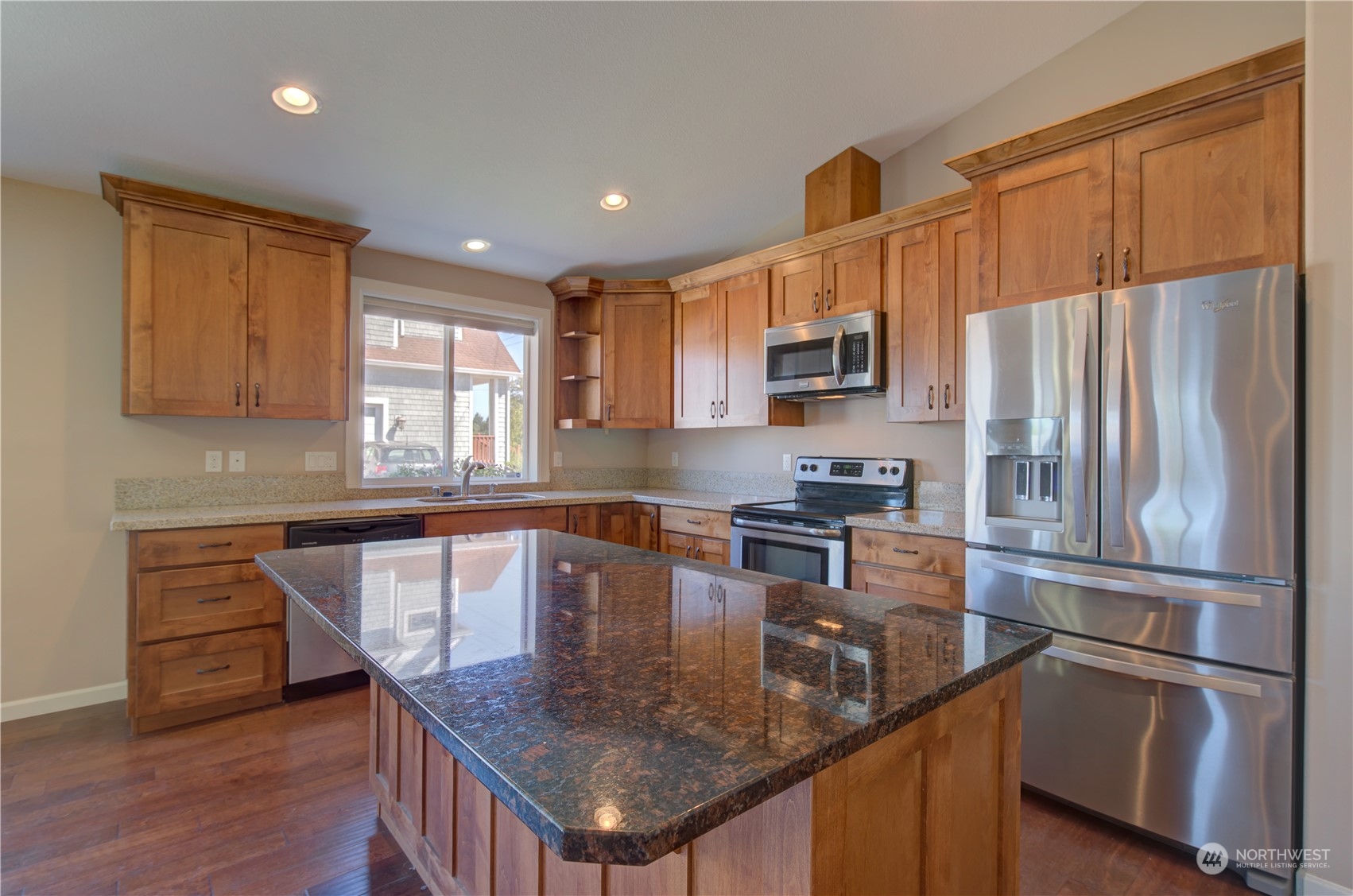 206 Pioneer Road West Long Beach, WA 98631 - Photo 10 of 39 a kitchen with stainless steel appliances granite countertop a sink a stove a refrigerator cabinets and a window