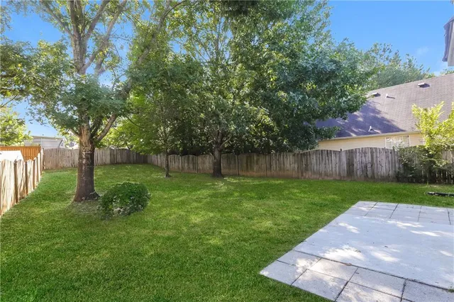 a view of a backyard with large trees