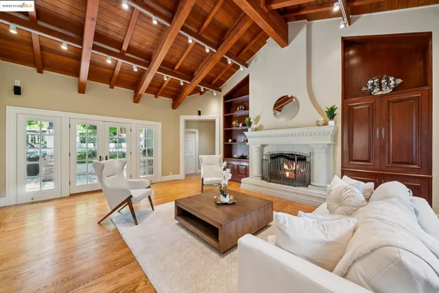 a living room with fireplace furniture and a large window