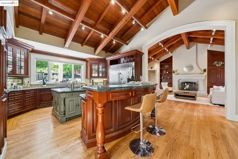 a kitchen with stainless steel appliances granite countertop a sink a counter space and a window