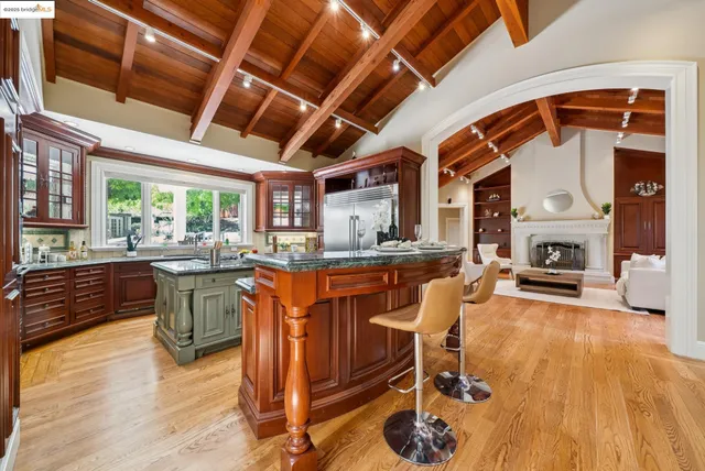 a kitchen with stainless steel appliances granite countertop a sink a counter space and a window