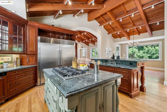 a kitchen with stainless steel appliances granite countertop a sink and a stove