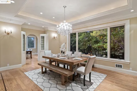 a view of a dining room with furniture and chandelier