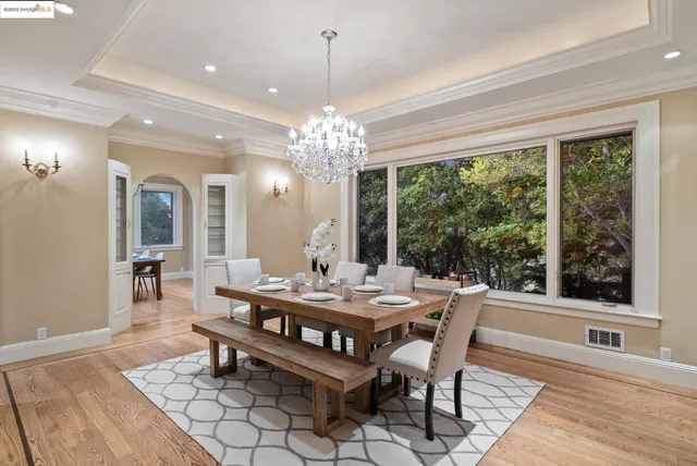 a view of a dining room with furniture and chandelier