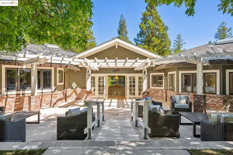 a view of a house with swimming pool and sitting area