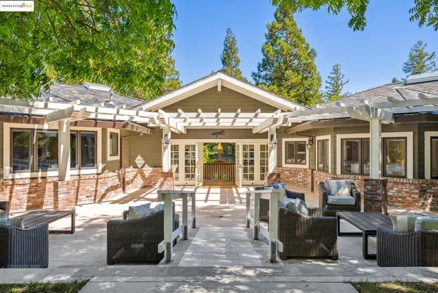 a view of a house with swimming pool and sitting area