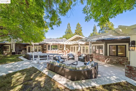 a front view of a house with swimming pool and patio