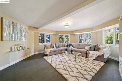 a living room with furniture and painting on the wall