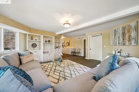a room with pool table and windows