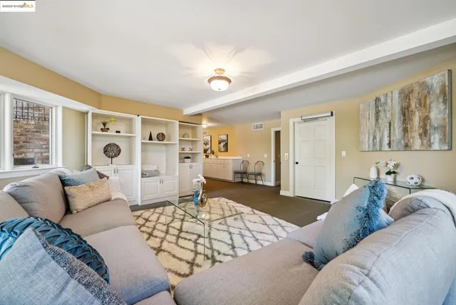 a room with pool table and windows