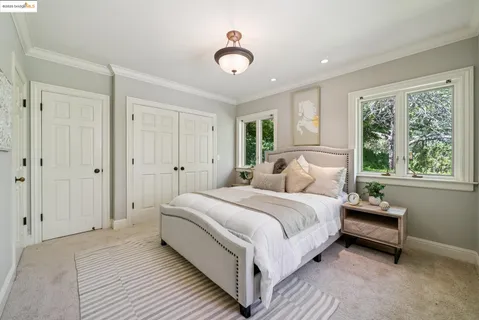 a spacious bedroom with a large bed and a window