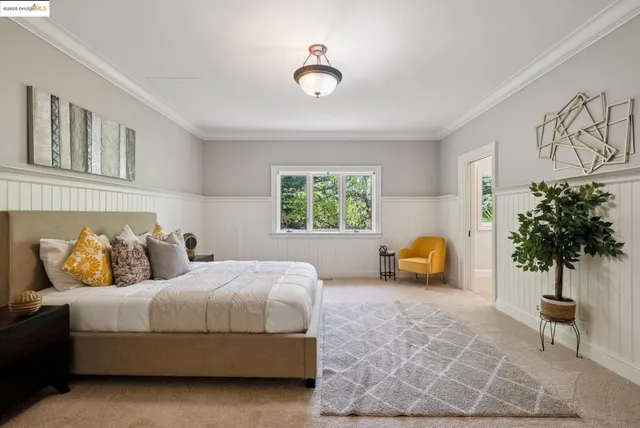 a bedroom with a bed and a potted plant