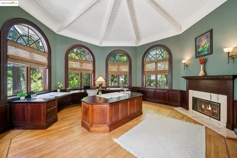 a living room with fireplace furniture and a large window