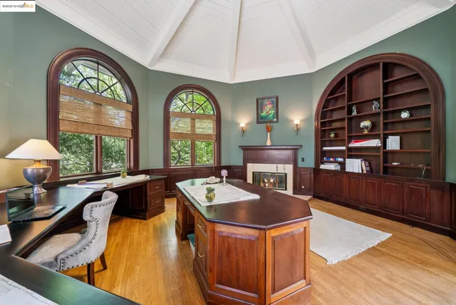 a dining room with wooden floor and a large window