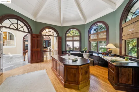 a living room with fireplace furniture and a large window