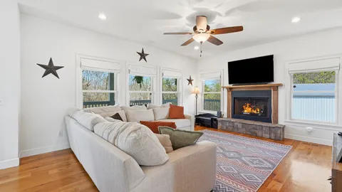 a living room with furniture fireplace and a flat screen tv